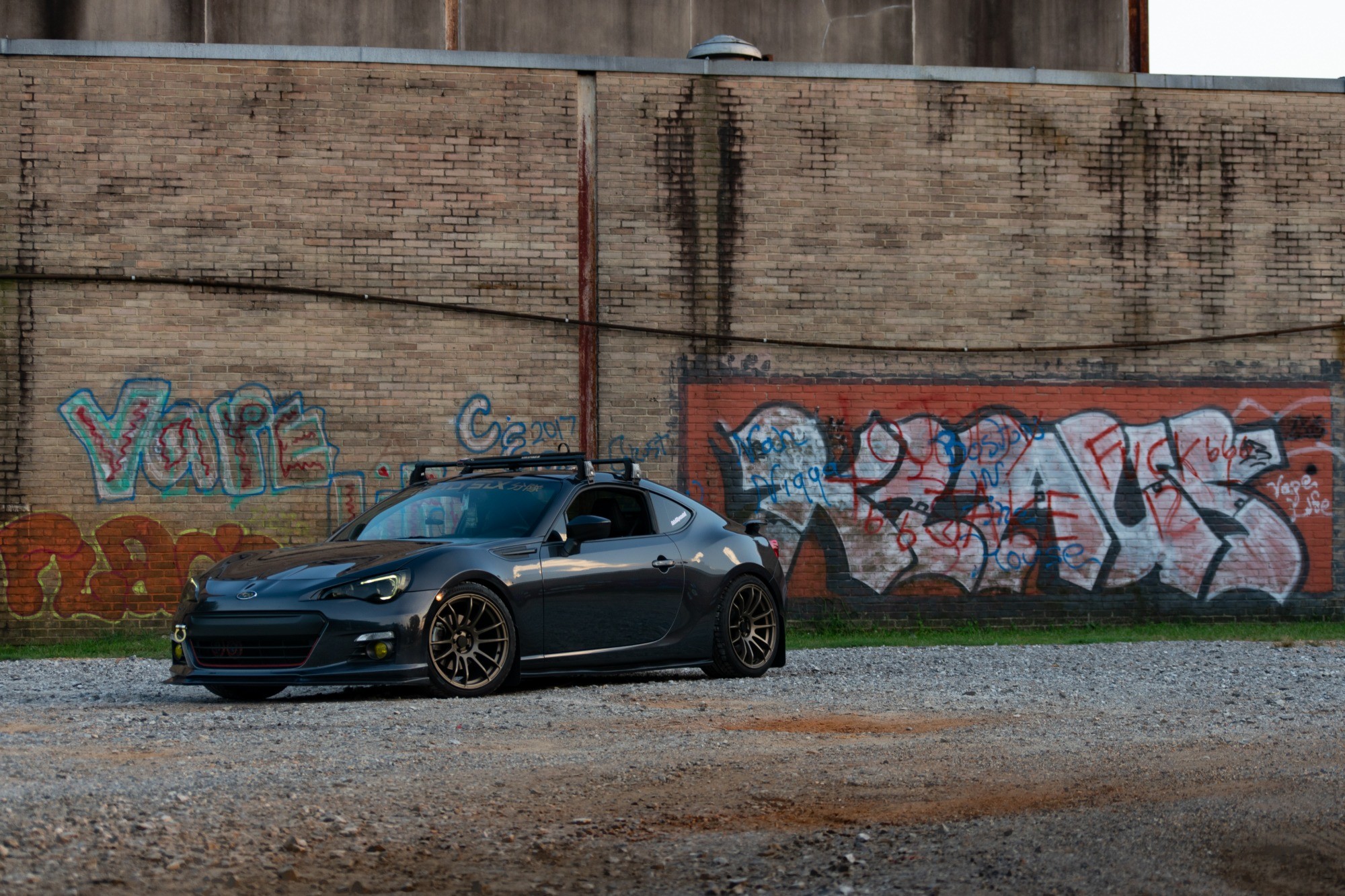 2016 Subaru BRZ on bronze AVID1 AV-20 wheels with Tein coilovers, flush fitment, rear three quarter view
