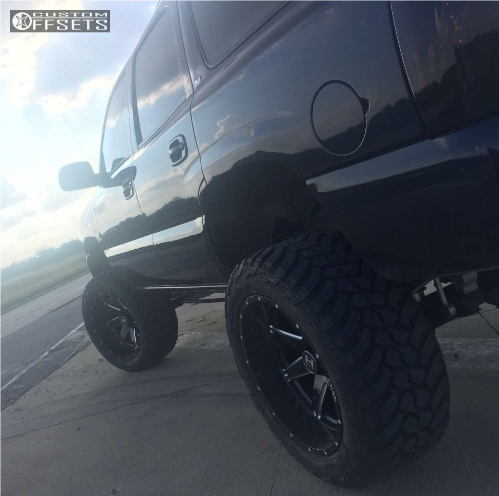 2004 GMC Yukon with 22x12 44 Hostile Alpha and 325/50R22 AMP Mud